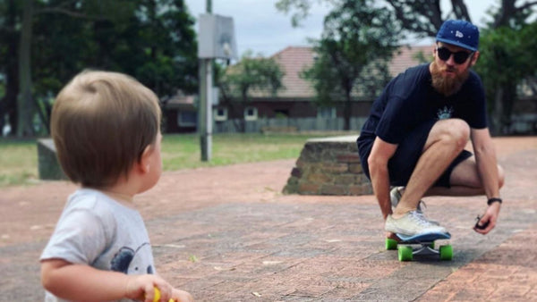 Rad Dad on skateboard son on tricycle