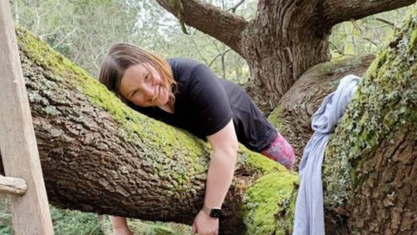 Kylie Eastley in a large tree